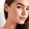 Nahaufnahme eines Ohres mit den Halo Honey Studs – goldene Edelstahl-Ohrstecker mit PVD-Beschichtung